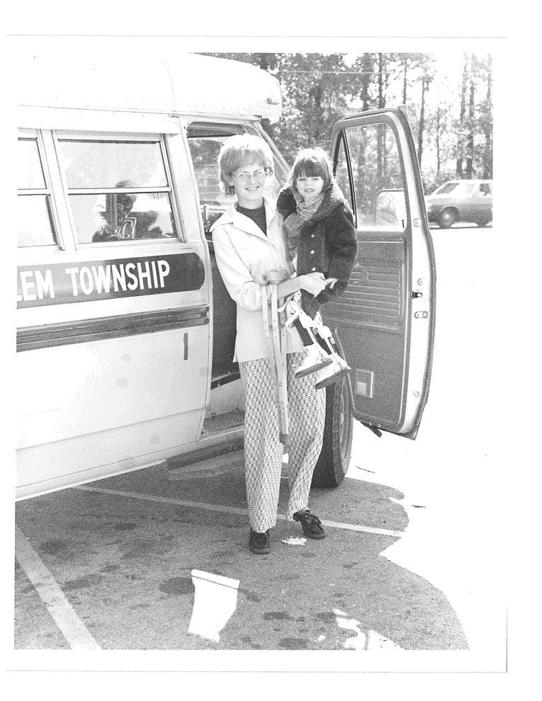 Archival black-and-white photograph of two women standing beside an Easterseals van, from the organization's history advocating for disability rights.